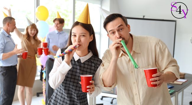 party hats people enjoying an office party at work