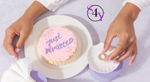 a divorce cake with a ring next to it